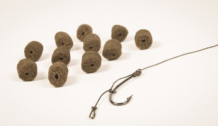 Close Up of Carp Hook pellets isolated on white background .の写真素材