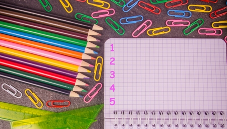 School supplies on black background ready for your design. Back to school.