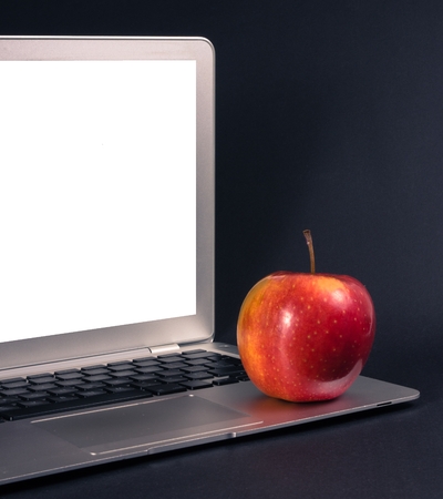 Modern laptop computer on dark background. The concept of work in the office.
