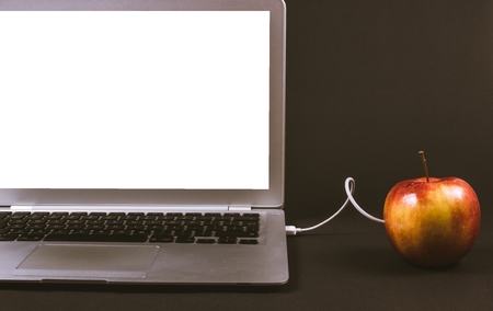 Modern laptop computer on dark background. The concept of work in the office.の写真素材