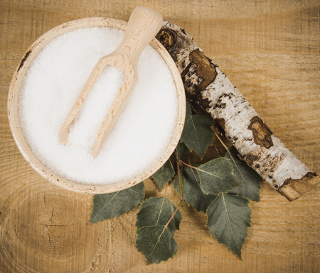 Xylitol - sugar substitute for diabetics. Birch sugar on wooden background.の写真素材
