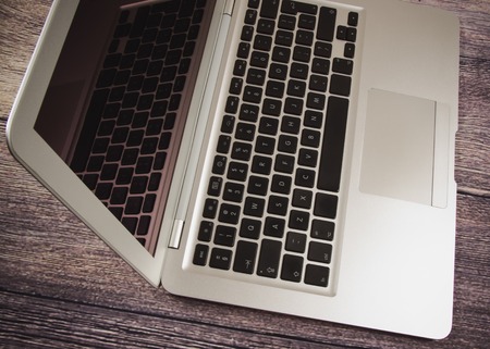 Modern laptop computer on dark background. The concept of work in the office.