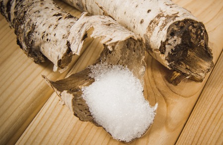 Xylitol - sugar substitute for diabetics. Birch sugar on wooden background.の写真素材