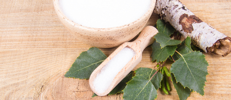 Xylitol - sugar substitute for diabetics. Birch sugar on wooden background.の写真素材