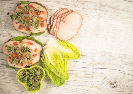 Sandwiches with lettuce, ham and broccoli sprouts. Healthy breakfast concept.の写真素材