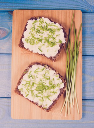 Sandwiches with granulated white cheese and chives. Healthy breakfast concept.の写真素材