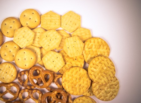 Mix of snacks : pretzels, crackers, cookies. Close Up.