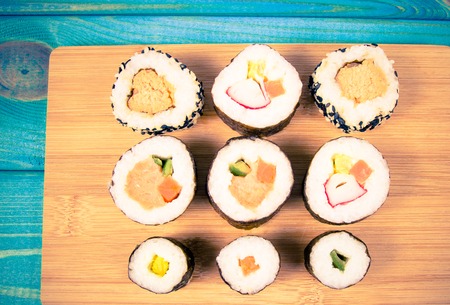Different types of sushi rolls on a blue background. Close Up.の写真素材