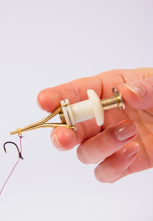 Fishing device for putting on the bait. Method feeder baits.の写真素材