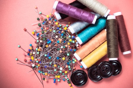 Accessories for needlework. Spools of thread, buttons, measuring tape, sewing supplies.の写真素材