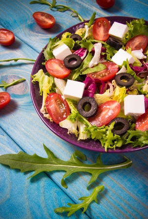 Conception of healthy eating. Fresh vegetable salad with feta cheese.の写真素材