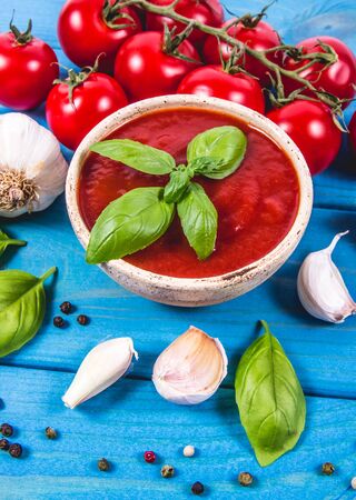 Sauce from fresh tomatoes with garlic and basil. The concept of a healthy diet.の写真素材