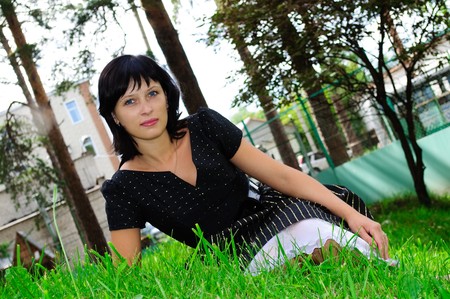 girl sitting on green grassの写真素材