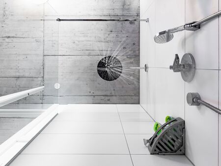 Looking straight up to the shower head from below in a bathroom of a modern home with a concrete industrial ceiling. Water drops start falling down towards the floor.の写真素材
