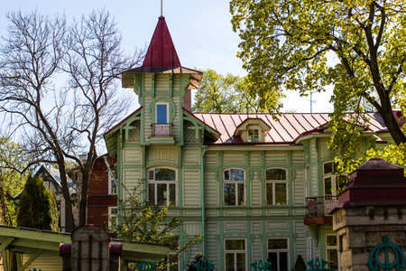 Beautiful baltic wooden house in Tallinn, sunny day, trees aroundの写真素材