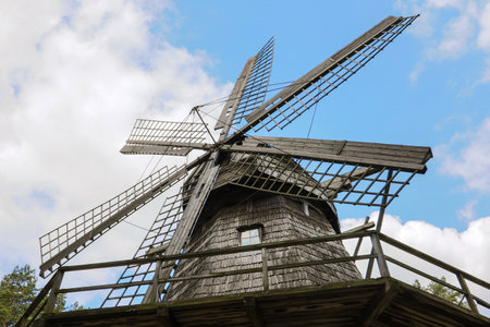 Old historic wooden windmill in detail in Latvia, blue skyの写真素材