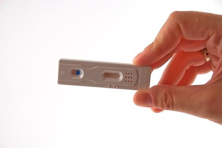 Pregnancy test hold in a hand isolated on a white backgroundの写真素材