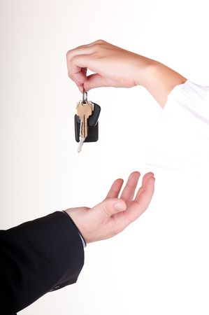 Man is getting a key to his new car from a womanの写真素材