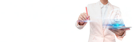 A person in a white shirt and pink pants uses a tablet to interact with a glowing blue holographic heart and digital data.の写真素材