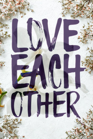 A heartfelt message in bold purple lettering reads 'LOVE EACH OTHER' against a white background, framed by delicate floral elements.の写真素材