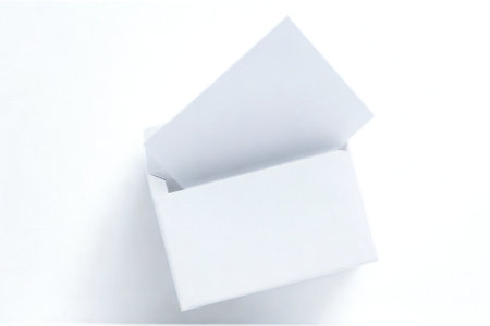 A minimalist composition of white geometric shapes, appearing as stacked boxes and planes, against a stark white backdrop.の写真素材