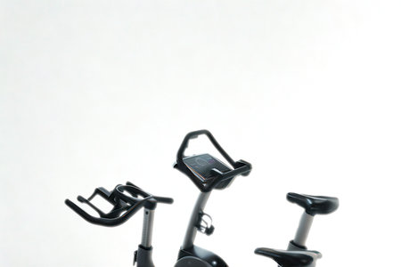 Three stationary exercise bikes are displayed against a clean white background, showcasing different designs and features for indoor cycling workouts.の写真素材