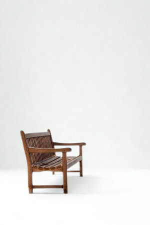 A single, empty wooden bench with a woven seat and back sits on a plain white background.の写真素材