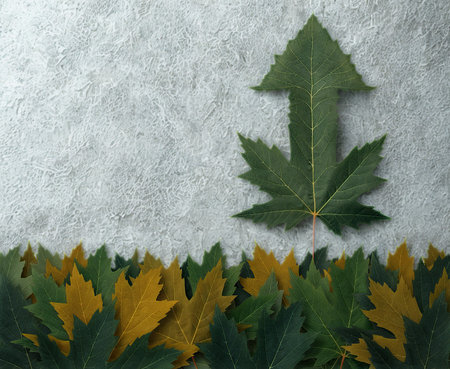 A green leaf shaped into an upward arrow stands tall against a textured background, with a line of colorful autumn leaves below.の写真素材