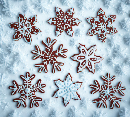 A collection of beautifully decorated snowflake-shaped cookies, perfect for a winter celebration or Christmas treat.の写真素材