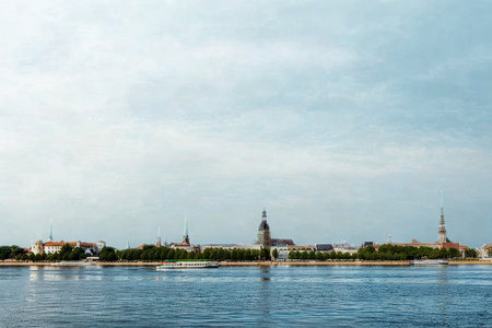 A wide shot shows the historic St Petersburg skyline with its iconic spires and buildings, reflected in the calm waters of the Neva River under a cloudy sky.の写真素材