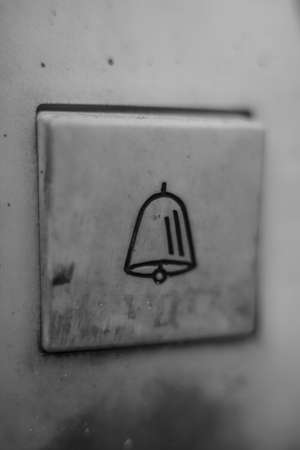 A closeup shot of a bell on a metal panel with a blurred backgroundの写真素材