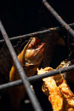 Dried fish on a grill, close-up, selective focus.