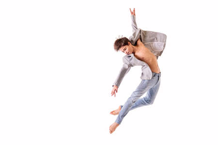 Ballet dancer teenage boy jumping barefoot, isolate on a white background.の写真素材