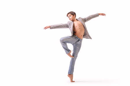 teenage ballet dancer poses barefoot, isolated on white background.の写真素材