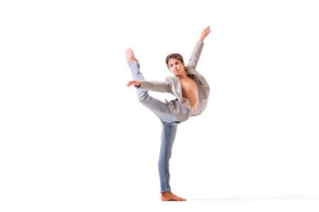 teenage ballet dancer poses barefoot, isolated on white background.の写真素材