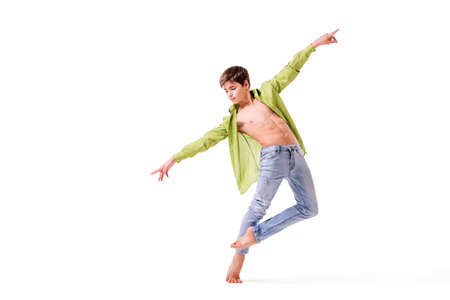 teenage ballet dancer poses barefoot, isolated on white background.の写真素材