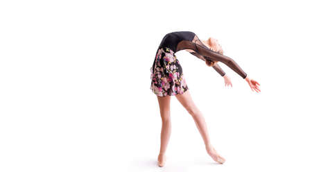 young ballerina in pointe shoes poses in graceful pose isolated on white backgroundの写真素材