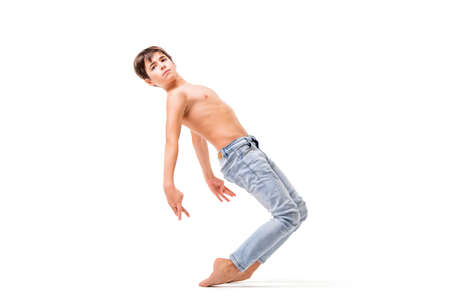 teenage ballet dancer poses barefoot, isolated on white background.の写真素材