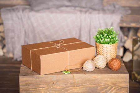 The box is made of brown cardboard, tied with a rope. Handmade gift.の写真素材