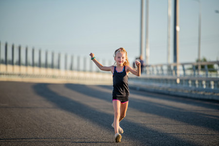 Girl runs on a sunny summer eveningの写真素材