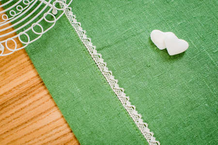 hearts made of refined white sugar lie on the green linen fabricの写真素材