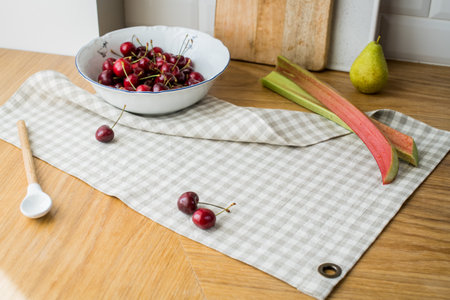 ripe red sweet cherries lying on the table in a dish and on a linen napkin.の写真素材
