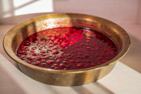 strawberry jam, red berries in syrup close-up in a copper basinの写真素材