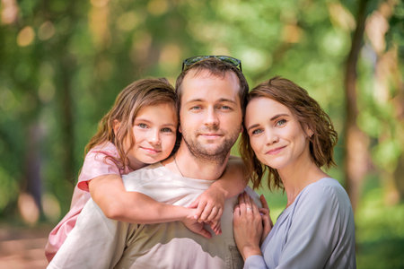 Portrait of a happy traditional family on a walk in a summer parkの写真素材