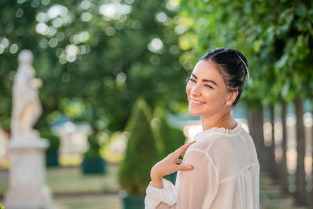 Close up portrait of young romantic woman walking in the parkの写真素材