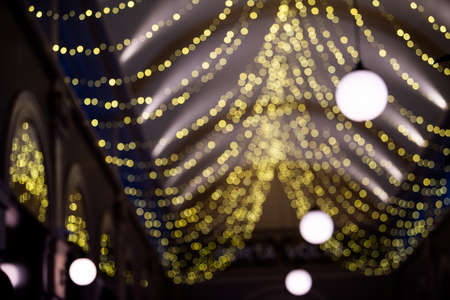 Abstract blurred background with colorful bokeh circles. Urban lifestyle background of street lights and garlands christmas in winterの写真素材