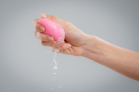 Hand with makeup sponges on white backgroundの写真素材