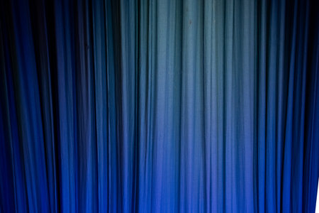 Blue theatre classic curtain. Visible fabric texture .Background, copy space.の写真素材