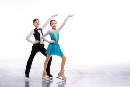 Young figure skaters in elegant ice dance - sports couples at competition, isolated on white background.の写真素材