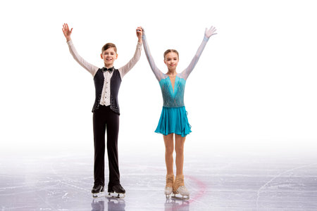 Young figure skaters in elegant ice dance - sports couples at competition, isolated on white background.の写真素材